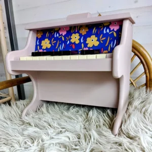 Détail du tissu à grosses fleurs sur le piano en bois rose poudré